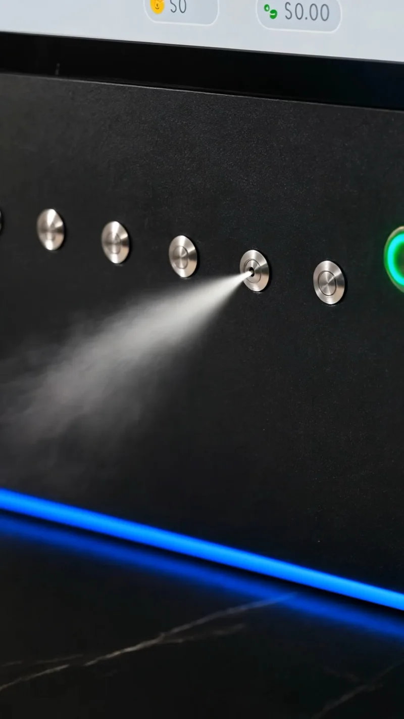 Close-up of fine fragrance mist being sprayed from a vending machine nozzle